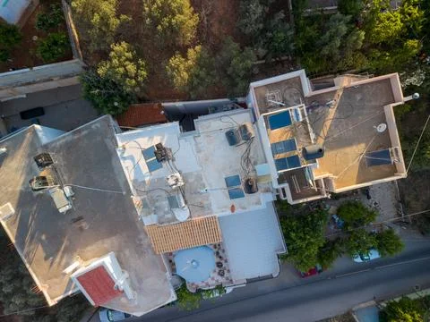 Top Down Drone View of House Rooftops with Solar Panels and Water Heaters 스톡 사진