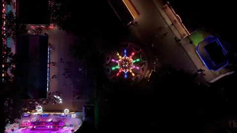 Top down drone view of illuminated fairground ride at night Stock Footage 343839945