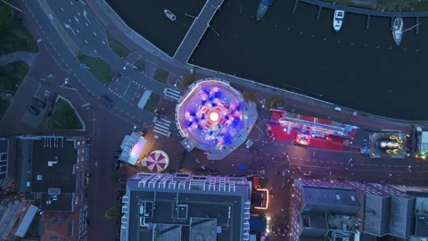 Top down drone view of illuminated fairground at dusk Видео 345255707