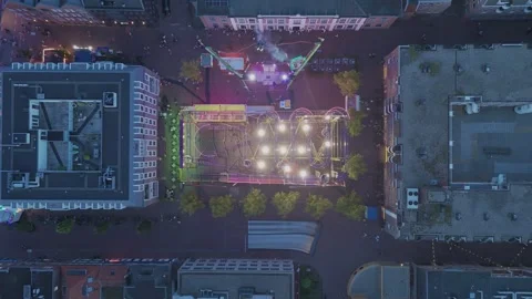 Top down drone view of illuminated fairground at dusk Видео 345255718