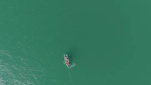 Top-down drone view of a kayaker crossing emerald waters of the Drina River Video stock 336730057