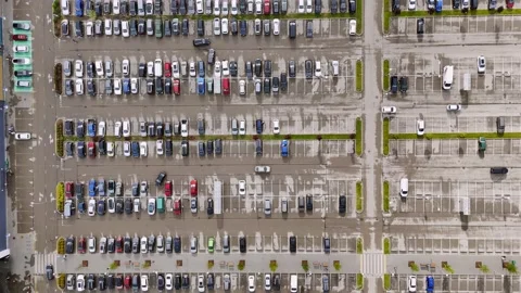 Top-down drone view of a large retail parking lot, showing rows of parked cars Stock Footage 340920177