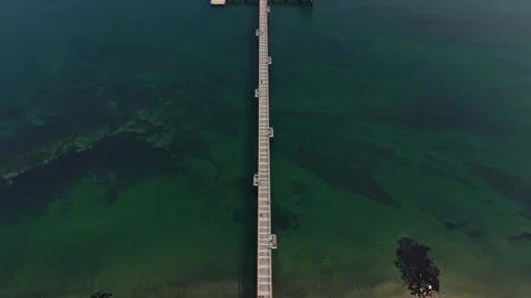 Top down drone view of long pier and beach Stock Footage 338186490