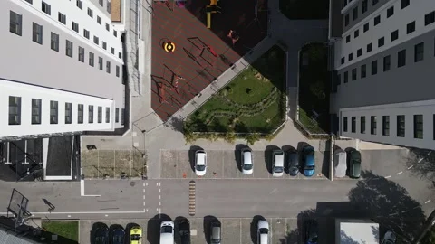 Top-down drone view of a modern residential courtyard with a playground, green 스톡 동영상 287183711