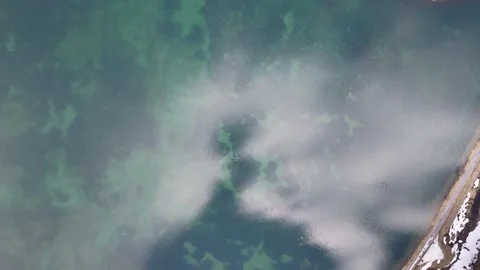 Top down drone view of Obersee lake shoreline and clouds in Glarus Switzerland Stock Footage 337788509