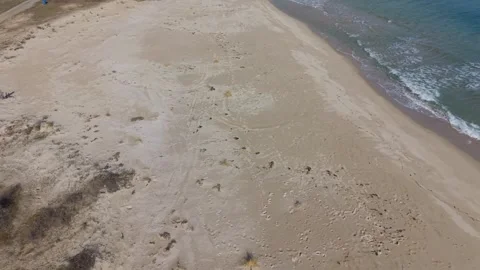 Top down drone view of ocean surf meeting golden shore Stock Footage 328571898