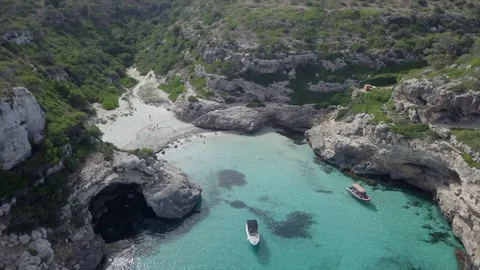 Top down drone view over a bay with crystal clear water and white boats. Video stock 221738124