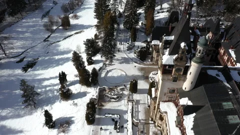 Top-down drone view of Peles Castle courtyard in winter, Sinaia Romania Stock Footage 321054715