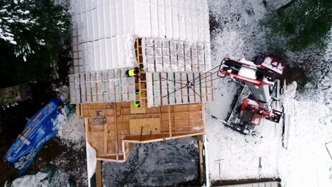 Top Down Drone View Roof Construction With Workers And Crane in Winter Stock Footage 334132443