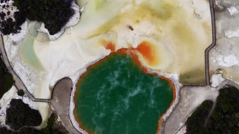 Top-down drone view of Rotorua’s geothermal terrain, revealing a deep emerald Stock Footage 342332996
