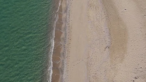 Top-down drone view of sandy beach, shoreline waves and turquoise water Stock Footage 321966617