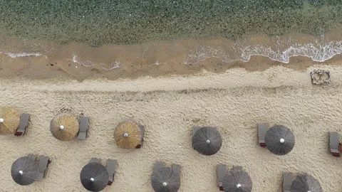 Top down drone view of sandy beach with sun umbrellas and waves, Greece Stock Footage 327655520