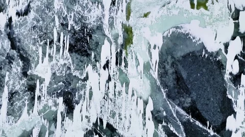 Top-down drone view of sea ice and dark water forming abstract winter patterns Stock Footage 332091668
