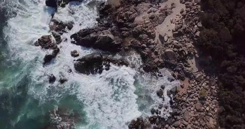 Top-Down Drone View of Sea Waves Crashing onto a Sandy Beach Shore Stock Photos