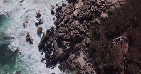Top-Down Drone View of Sea Waves Crashing onto a Sandy Beach Shore Stock Photos