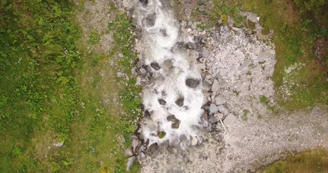 Top Down Drone view of small stream of water in the Alps Stock Footage 146584370