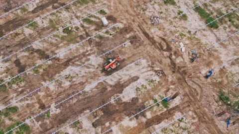 Top Down Drone View of Solar Farm Construction Site with Tractor Machinery Stock Footage 331966742