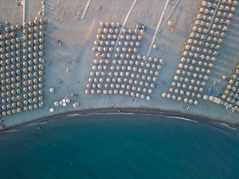 Top Down Drone View of Straw Umbrellas Pattern at Velipoja Beach Stock Photos