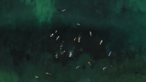 Top down drone view at surfers at the ocean, Bali, Indonesia, 4k Stock Footage 122155180