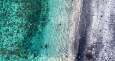 Top Down Drone View of Swimmers in Turquoise Water at Amed Beach Bali Stock Footage 334373840