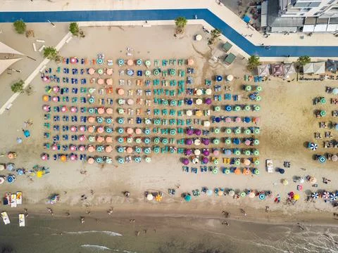 Top Down Drone View of Swimmers Beach Umbrellas and Promenade Durres Stock Photos