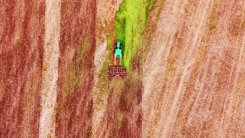 Top down drone view of tractor cultivating soil in Bulgaria Stock Footage 335693374