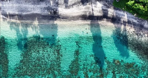 Top Down Drone View of Turquoise Water and Black Sand Beach in Amed Bali Stock Footage 334376346