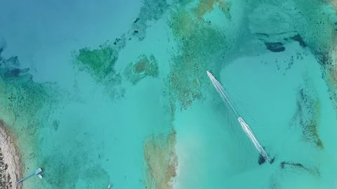 Top down drone view of two speedboats leaving white foam trails on crystal .. Stock Photos