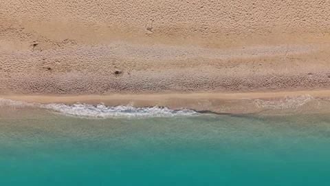 Top Down Drone View of Waves Washing Ashore on Sandy Beach 動画素材 337003654