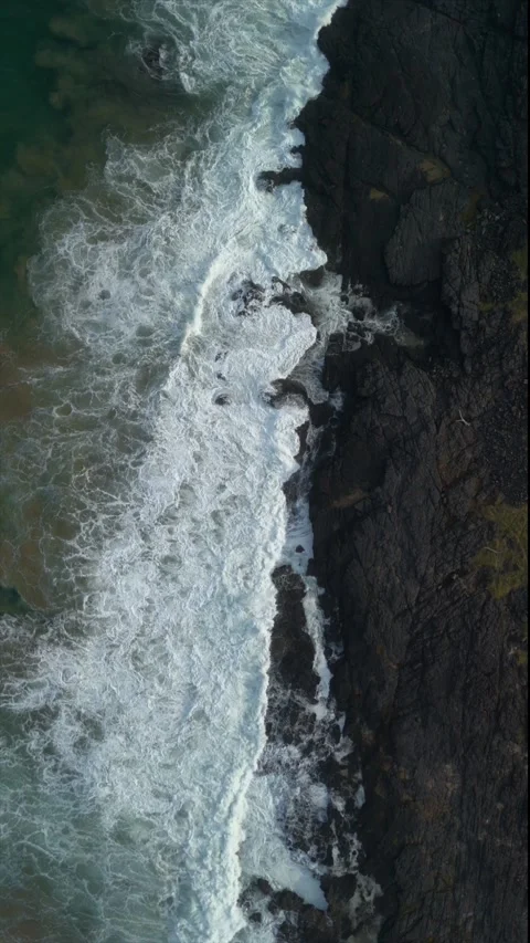 Top-Down Drone View of Waves Crashing on Rocky Wild Coast, South Africa.ver.. Stock Footage 341427889