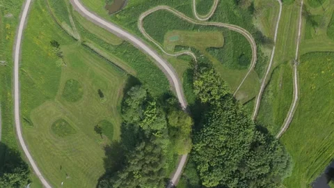 Top down drone view of winding paths in green park landscape Video stock 337351447