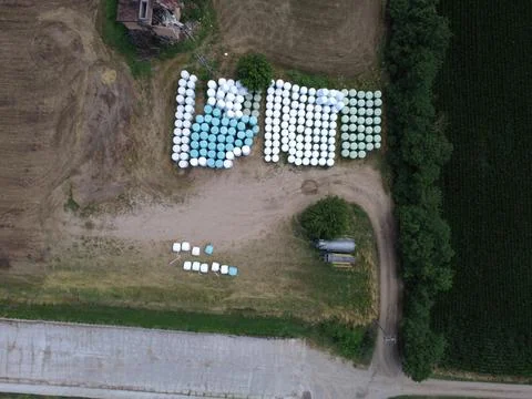 Top Down Drone View of Wrapped Silage Bales Stored on Farm Stock Photos