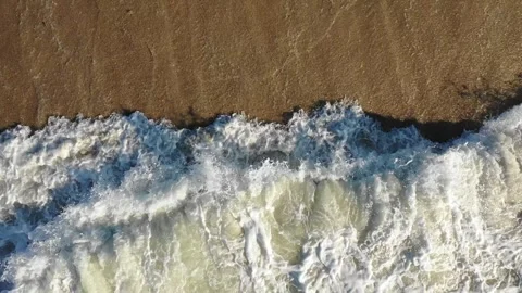 Top Down Drone of Waves Rolling Onto Sandy Beach Stock Footage 329735156