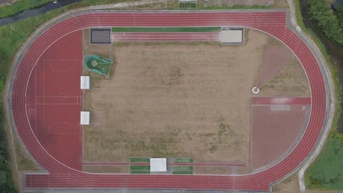 Top down drone zoom in on athletics running track Stock Footage 343839001