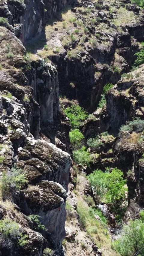 Top down of dry volcanic canyon slopes and ancient basalt pillars in Kazakhstan Stock Footage 338124106