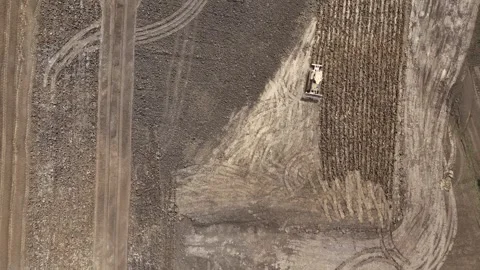 Top down earthmoving machinery on industrial construction terrain drone aerial Video stock 336335209