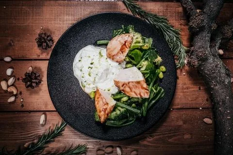 Top-down, elevated view of a sophisticated grilled chicken dish. The chicken  Stock Photos