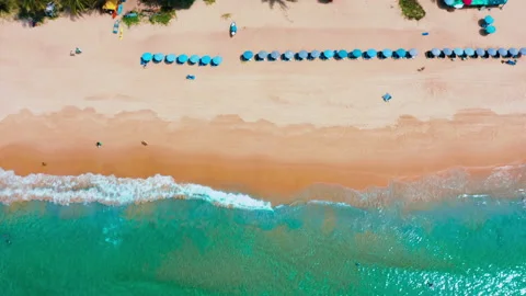 Top down of empty Karon Beach, Phuket, white sand, Umbrellas, sea waves Stock Footage 173594467