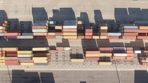 TOP DOWN: Empty streets run past colorful freight containers and loading cranes. Stock Footage 118076300