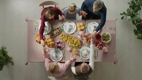 Top Down of Family Praying before Easter Dinner Stock Footage 224551696