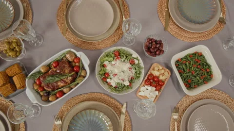 Top Down of Festive Holiday Dinner Table with Roasted Meat and Salad Stock Footage 340329753