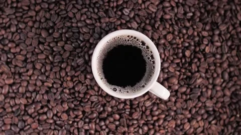 Top Down Flat Lay White Ceramic Mug Black Coffee Roasted Beans Video stock 337513976
