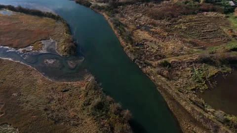 Top down flight over salt marsh and stream - 4K Video stock 227991772