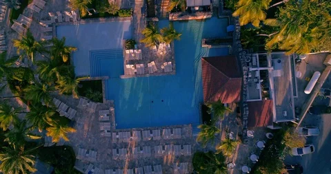 Top down fly over Empty hotel pool area no tourist due to corona crisis. Stock-Footage 128472109