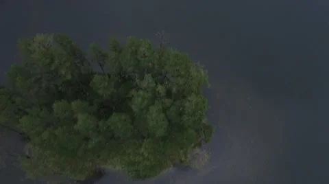 TOP DOWN FLY OVER TINY ISLAND. Stock-Footage 65343974