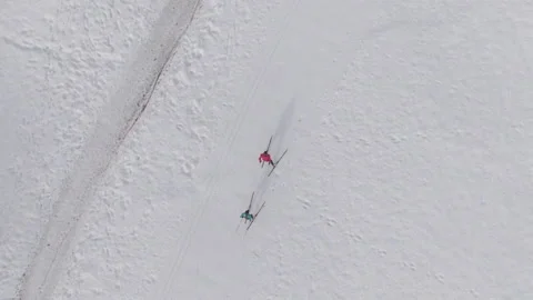 TOP DOWN: Flying above two female athletes training nordic skiing in Slovenia. Stock Footage 165705317