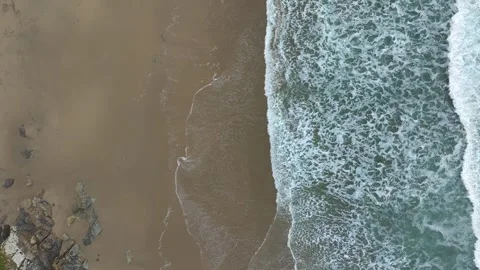 Top Down Of Foamy Waves Rolling Into Sandy Coastline Of The Sea - Drone Shot Stockbeeldmateriaal 263038178