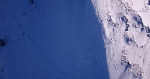 Top down to forward reveal of snow mountain ridge Stock Footage 93456222
