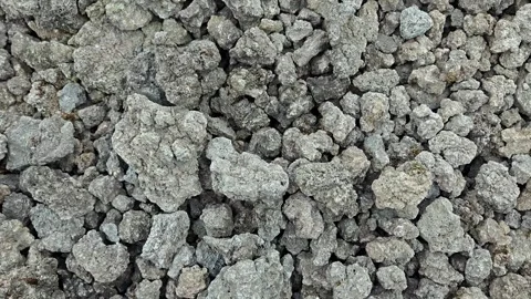Top down full frame view of rough volcanic rock stones and gray pebbles texture Stock Footage 339757414