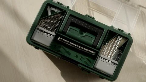 Top down green tool case. Carpenter at work, tools for drilling holes close-up Stock Photos